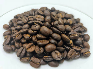 Roasted coffee beans on a white plate
