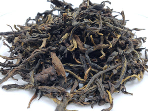 A close-up image of dry black tea leaves.