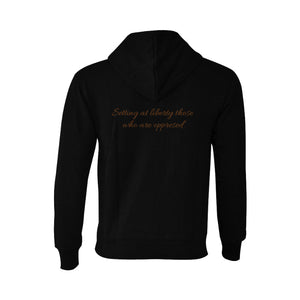 Back view of black Teshuah Tea Co. hoodie with ‘Setting at liberty those who are oppressed’ text.