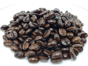 A pile of whole bean Mexican decaf dark roast coffee.